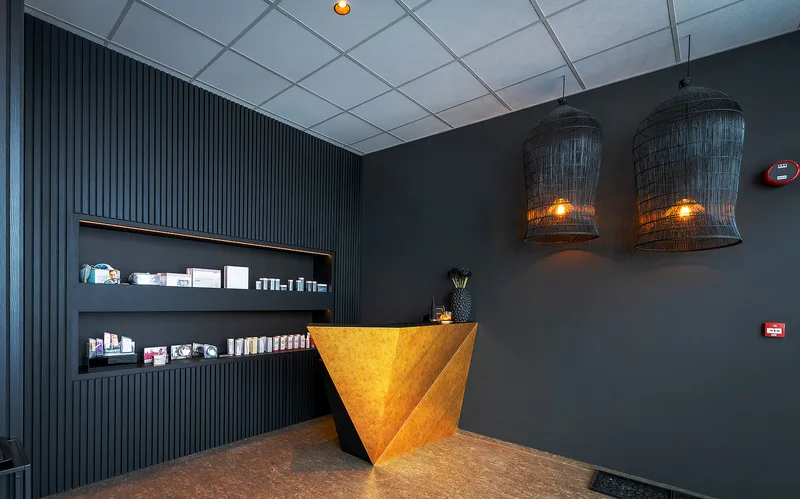 Custom gold faceted reception desk by Preiss Workshop